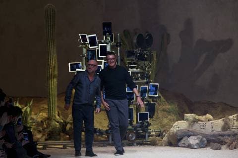 Domenico Dolce (L) and Stefano Gabbana acknowledge the applause of the audience after presenting their Dolce & Gabbana men s Fall-Winter 2016-2017 show collection during Milan Fashion Week in Milan, Italy, on Jan. 16, 2016. Inspired by the iconic Spaghetti Western movies directed by an Italian director Sergio Leone in the 1960s, which brought the Italian movie industry to the attention of the international crowds, the collection shows a contrast between the past (via the embroideries and embellishments of the Wild West) and the present (the shapes, cut, and fit). ) ITALY-MILAN-D&G-FASHION WEEK JinxYu 