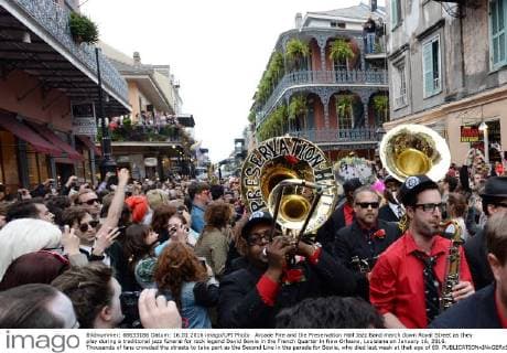Arcade Fire and the Preservation Hall Jazz Band march down Royal Street as they play during a traditional jazz funeral for rock legend David Bowie in the French Quarter in New Orleans, Louisiana on January 16, 2016. Thousands of fans crowded the streets to take part as the Second Line in the parade for Bowie, who died last week at that age of 69.  NOP20160116111 PATxBENIC