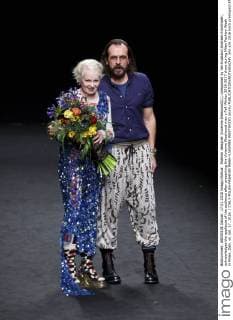 Fashion designer Vivienne Westwood(L), companied by her husband Andreas Kronthaler, acknowledges the applause of the audience after presenting the Vivienne Westwood men s Fall-Winter 2016-2017 show during Milan Fashion Week in Milan, Italy, on Jan. 17, 2016. ) ITALY-MILAN-FASHION WEEK-VIVIENNE WESTWOOD JinxYu 