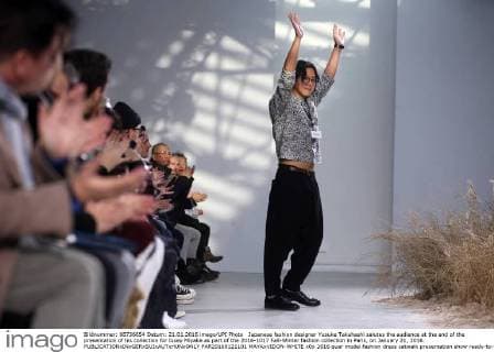 Japanese fashion designer Yusuke Takahashi salutes the audience at the end of the presentation of his collection for Issey Miyake as part of the 2016-1017 Fall-Winter fashion collection in Paris, on January 21, 2016.  PAR20160121101 MAYAxVIDON-WHITE