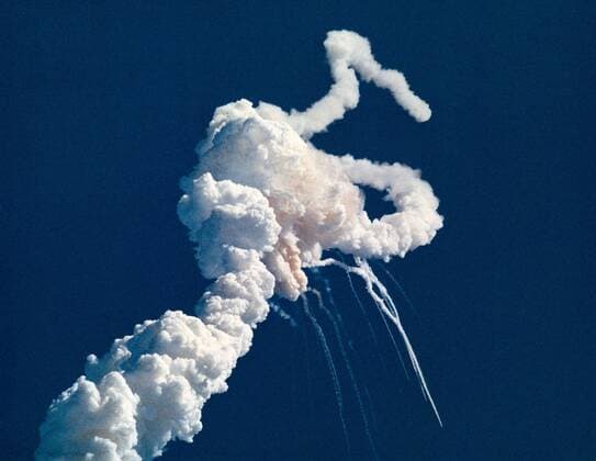 Main engine exhaust, solid rocket booster plume and an expanding ball of gas from the external tank is visible seconds after the launch of the Space Shuttle Challenger on January 28, 1986. At 11:39 a.m. EST, the Space Shuttle Challenger and her seven-member crew were lost when a ruptured O-ring in the right Solid Rocket Booster caused an explosion 73 seconds after launch. NASA  WAX2016012502 NASA......