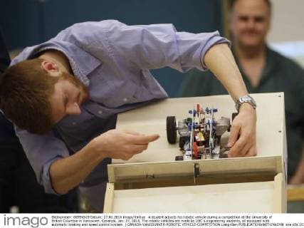 A student adjusts his robotic vehicle during a competition at the University of British Columbia in Vancouver, Cananda, Jan. 27, 2016. The robotic vehicles are made by UBC s engineering students, all equipped with automatic braking and speed control system. ) CANADA-VANCOUNVER-ROBOTIC VEHICLE-COMPETITION LiangxSen 