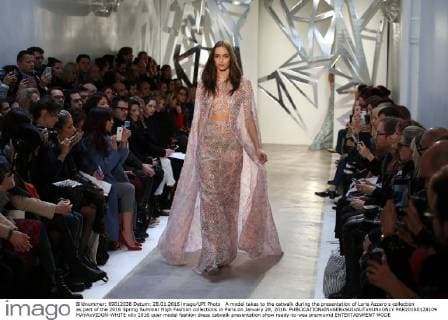 A model takes to the catwalk during the presentation of Loris Azzaro s collection as part of the 2016 Spring Summer High Fashion collections in Paris on January 28, 2016.  PAR20160128109 MAYAxVIDON-WHITE