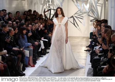 A model takes to the catwalk during the presentation of Loris Azzaro s collection as part of the 2016 Spring Summer High Fashion collections in Paris on January 28, 2016.  PAR20160128110 MAYAxVIDON-WHITE
