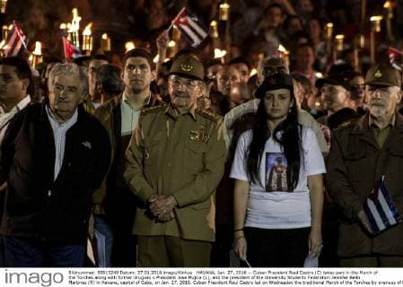HAVANA, Jan. 27, 2016 -- Cuban President Raul Castro (C) takes part in the March of the Torches along with former Uruguay s President Jose Mujica (L), and the president of the University Students Federation Jennifer Bello Martinez (R) in Havana, capital of Cuba, on Jan. 27, 2016. Cuban President Raul Castro led on Wednesday the traditional March of the Torches by avenues of Havana to honor the national hero Jose Marti in the 163rd anniversary of his birth. Stringer) CUBA-HAVANA-MARCH OF THE TORCHES e Joaquin 