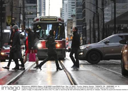 Dec. 14, 2015 - Toronto, Ontario, Canada - TORONTO, ON - DECEMBER, 14 - A streetcar makes its way through traffic along King street at Bay..King Stteet west will be one of the targets of Uber heading west towards Liberty Village. An area under served by the TTC..Uber is launching its new commuting offering UberHop on Tuesday. We talk to experts to find out whether this is legal -- or is this actually transit..NOTE: more images in EMMA.December 14, 2015 Toronto Canada  - ZUMAt14_