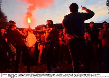 Feb. 1, 2016 - Cairo, Cairo, Egypt - Al Ahly fans, also known as Ultras , light flares and shout slogans at al-Ahly club s training stadium marking the fourt anniversary of killing al-Ahly fans in what known as the Port Said massacre , on February 1, 2016. On 1 February 2012, a massive riot occurred at Port Said Stadium in Port Said city, Egypt, following an Egyptian Premier League football match between El Masry and El Ahly clubs. At least 74 people were killed and more than 500 were injured after thousands of El Masry spectators stormed the stadium stands and the pitch Cairo Egypt - ZUMAap3_