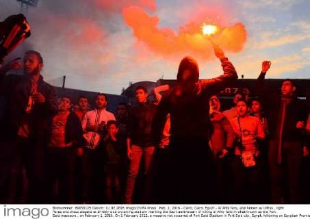 Feb. 1, 2016 - Cairo, Cairo, Egypt - Al Ahly fans, also known as Ultras , light flares and shout slogans at al-Ahly club s training stadium marking the fourt anniversary of killing al-Ahly fans in what known as the Port Said massacre , on February 1, 2016. On 1 February 2012, a massive riot occurred at Port Said Stadium in Port Said city, Egypt, following an Egyptian Premier League football match between El Masry and El Ahly clubs. At least 74 people were killed and more than 500 were injured after thousands of El Masry spectators stormed the stadium stands and the pitch Cairo Egypt - ZUMAap3_