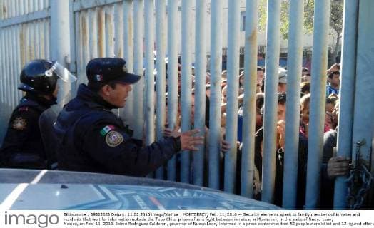 MONTERREY, Feb. 11, 2016 -- Security elements speak to family members of inmates and residents that wait for information outside the Topo Chico prison after a fight between inmates, in Monterrey, in the state of Nuevo Leon, Mexico, on Feb. 11, 2016. Jaime Rodriguez Calderon, governor of Nuevo Leon, informed in a press conference that 52 people were killed and 12 injured after a fight between two rival fractions of inmates broke in the Topo Chico prison. Str) (ce) MEXICO-MONTERREY-SECURITY-PRISON e STR 
