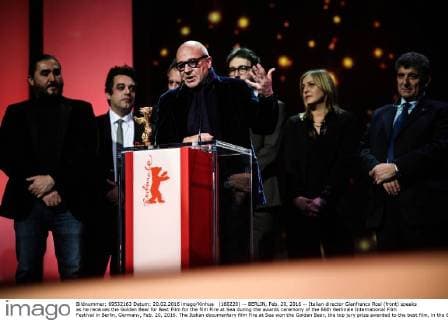 (160220) -- BERLIN, Feb. 20, 2016 -- Italian director Gianfranco Rosi (front) speaks as he receives the Golden Bear for Best Film for the film Fire at Sea during the awards ceremony of the 66th Berlinale International Film Festival in Berlin, Germany, Feb. 20, 2016. The Italian documentary film Fire at Sea won the Golden Bear, the top jury prize awarded to the best film, in the 66th Berlin International Film Festival on Saturday. ) GERMANY-BERLIN-BERLINALE INTERNATIONAL FILM FESTIVAL-AWARDS CEREMONY-GOLD BEAR-GIANFRANCO ROSI ZhangxFan 