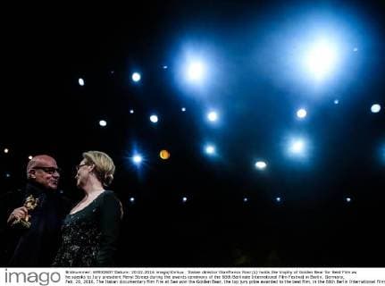 Italian director Gianfranco Rosi (L) holds the trophy of Golden Bear for Best Film as he speaks to Jury president Meryl Streep during the awards ceremony of the 66th Berlinale International Film Festival in Berlin, Germany, Feb. 20, 2016. The Italian documentary film Fire at Sea won the Golden Bear, the top jury prize awarded to the best film, in the 66th Berlin International Film Festival on Saturday. ) GERMANY-BERLIN-BERLINALE INTERNATIONAL FILM FESTIVAL-AWARDS CEREMONY-GOLD BEAR-GIANFRANCO ROSI ZhangxFan 