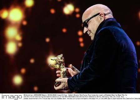 Italian director Gianfranco Rosi holds the trophy of Golden Bear for Best Film for the film Fire at Sea during the awards ceremony of the 66th Berlinale International Film Festival in Berlin, Germany, Feb. 20, 2016. The Italian documentary film Fire at Sea won the Golden Bear, the top jury prize awarded to the best film, in the 66th Berlin International Film Festival on Saturday. ) GERMANY-BERLIN-BERLINALE INTERNATIONAL FILM FESTIVAL-AWARDS CEREMONY-GOLD BEAR-GIANFRANCO ROSI ZhangxFan 