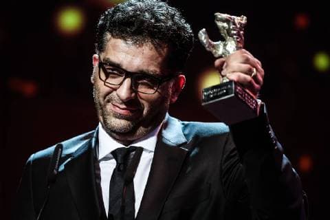 (160220) -- BERLIN, Feb. 20, 2016 -- Bosnian director Danis Tanovic holds the Silver Bear for Grand Jury Prize for the film Smrt u Sarajevu Mort a Sarajevo (Death in Sarajevo) during the awards ceremony of the 66th Berlinale International Film Festival in Berlin, Germany, Feb. 20, 2016. ) GERMANY-BERLIN-BERLINALE INTERNATIONAL FILM FESTIVAL-AWARDS CEREMONY ZhangxFan 