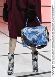 Feb. 21, 2016 - London, London, UK - Model on the catwalk holding a handbag at the ANYA HINDMARCH Autumn Winter 2016 show. Models, buyers, celebrities and the stylish descend upon London Fashion Week for the Autumn Winters 2016 clothes collection shows. London, UK. London UK  - ZUMAl94_