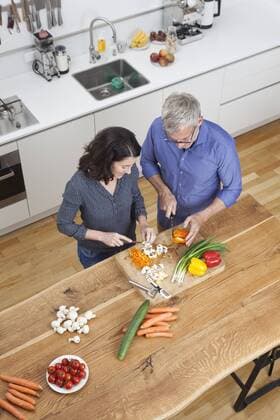 Mature couple preparing vegetables in kitchen model released Symbolfoto property released  RBF003732