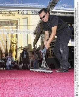 Feb. 24, 2016 - Los Angeles, California, U.S - A worker stretches out the red carpet for the Oscars in front of the Dolby Theatre in Los Angeles, Wednesday, February 24, 2016. The 88th Academy Awards will be held Sunday, February 28, 2016. Los Angeles U.S. - ZUMAc68_