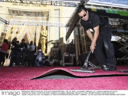 Feb. 24, 2016 - Los Angeles, California, U.S - A worker stretches out the red carpet for the Oscars in front of the Dolby Theatre in Los Angeles, Wednesday, February 24, 2016. The 88th Academy Awards will be held Sunday, February 28, 2016. Los Angeles U.S. - ZUMAc68_