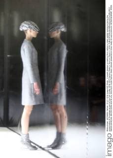 A model displays a creation from behind a mesh-walled enclosure during the presentation of Anrealage as part of the Fall-Winter 2016-2017 Fashion Week in Paris on March 1, 2016.  PAR20160301106 MAYAxVIDON-WHITE