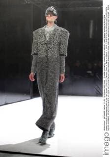A model displays a creation from behind a mesh-walled enclosure during the presentation of Anrealage as part of the Fall-Winter 2016-2017 Fashion Week in Paris on March 1, 2016.  PAR20160301111 MAYAxVIDON-WHITE