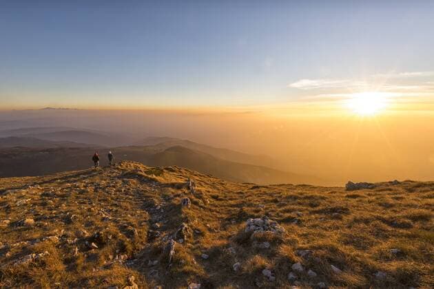 Italy, Marche, Monte San Vicino, two hikers looking at view at sunset model released Symbolfoto  LOMF000211