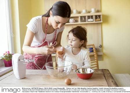 Mother and her little daughter baking together model released Symbolfoto property released  HAPF000159