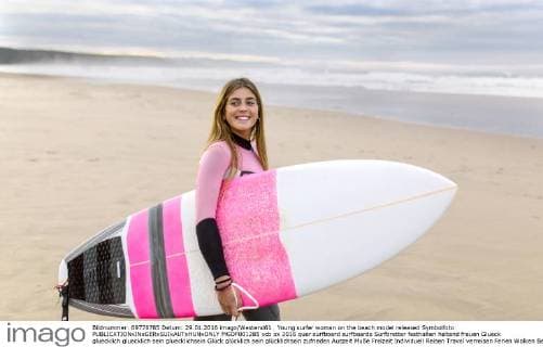 Young surfer woman on the beach model released Symbolfoto  MGOF001285