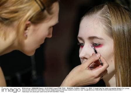 MOSCOW, RUSSIA. MARCH 11, 2016. A model has her make-up applied ahead of a runway show at the 2016 Mercedes Benz Fashion Week Russia at Manege Central Exhibition Hall. Sergei Bobylev TASS  TS019223