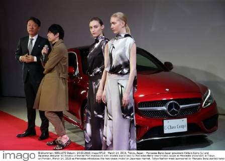 March 14, 2016, Tokyo, Japan - Mercedes Benz Japan president Kintaro Ueno (L) and Japanese designer Yu Amatsu of Hanae Mori manuscrit with models stand next to Mercedes-Benz new C-class coupe at Mercedes showroom in Tokyo on Monday, March 14, 2016 as Mercedes introduces the new coupe model on Japanese market. Tokyo fashion week sponsored by Merceds Benz started here on March 14 and runs through to the 19th.  (lwxa000286)