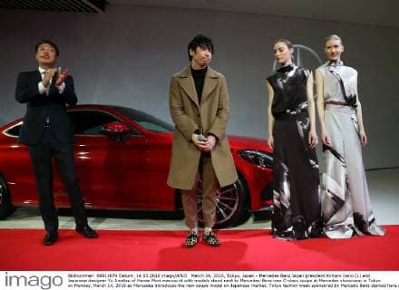 March 14, 2016, Tokyo, Japan - Mercedes Benz Japan president Kintaro Ueno (L) and Japanese designer Yu Amatsu of Hanae Mori manuscrit with models stand next to Mercedes-Benz new C-class coupe at Mercedes showroom in Tokyo on Monday, March 14, 2016 as Mercedes introduces the new coupe model on Japanese market. Tokyo fashion week sponsored by Merceds Benz started here on March 14 and runs through to the 19th.  (lwxa000289)
