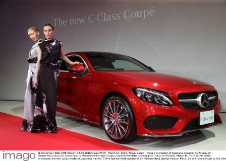 March 14, 2016, Tokyo, Japan - Models in creation of Japanese designer Yu Amatsu of Hanae Mori manuscrit stand next to Mercedes-Benz new C-class coupe at Mercedes showroom in Tokyo on Monday, March 14, 2016 as Mercedes introduces the new coupe model on Japanese market. Tokyo fashion week sponsored by Merceds Benz started here on March 14 and runs through to the 19th.  (lwxa000283)