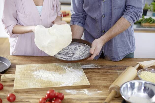 Couple preparing pizza dough in kitchen model released Symbolfoto property released  FMKF002403