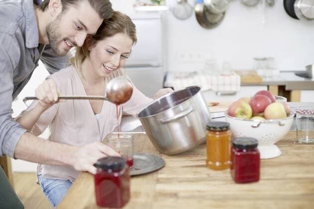 Couple in kitchen filling jam into jars model released Symbolfoto property released  FMKF002406
