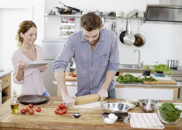 Couple preparing pizza dough in kitchen model released Symbolfoto property released  FMKF002355