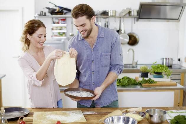 Couple preparing pizza dough in kitchen model released Symbolfoto property released  FMKF002404
