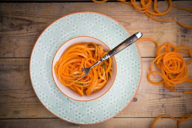 Bowl of spiralized carrot salad with spring onions  LVF004626