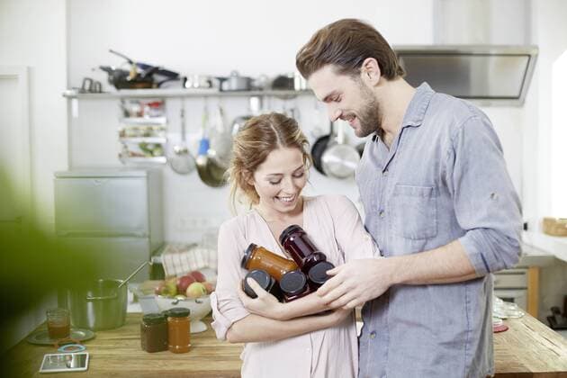 Couple with jam jars in kitchen model released Symbolfoto property released  FMKF002374