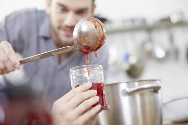 Couple filling jam into jars model released Symbolfoto property released  FMKF002407