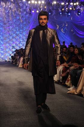 MUMBAI, INDIA - MARCH 29: Bollywood actor Arjun Kapoor displays the creation of fashion designer Manish Malhotra during the opening show of Lakme Fashion Week Summer Resort 2016, at Mehboob Studio, Bandra on March 29, 2016 in Mumbai, India. (Photo by Pramod Thakur Hindustan Times ) Lakme Fashion Week Summer Resort 2016