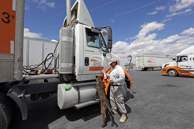 March 31, 2016 - Santa Teresa, NM, U.S. - K-9 security officer Santiago Ramirez and his dog Lord check a truck waiting in line to cross into the United States at the Santa Teresa-San Jeronimo border crossing, near Ciudad Juarez, Mexico, Thursday, March 31, 2016. Santa Teresa U.S. - ZUMAab1_