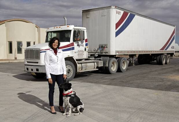 March 31, 2016 - Santa Teresa, NM, U.S. - Miriam Kotkowski, president of Omega Trucking, and her dog Bruno pose for a photo at their new offices in Santa Teresa, New Mexico, Thursday, March 31, 2016. Santa Teresa U.S. - ZUMAab1_
