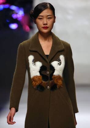Models showcase fashion designs by Zoual Yanti during China s fashion week in Beijing on March 31, 2016. Chinese fashion designers are becoming an international force with both European and American fashion houses looking at the new, fresh Chinese clothing-minds as potential partners in future clothing brands.  PEK2016033114 STEPHENxSHAVER