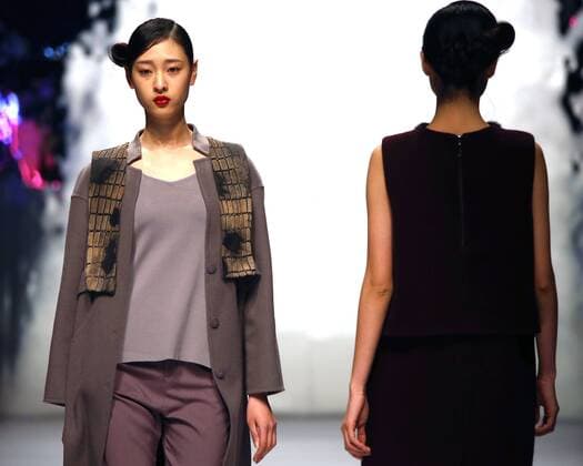 Models showcase fashion designs by Zoual Yanti during China s fashion week in Beijing on March 31, 2016. Chinese fashion designers are becoming an international force with both European and American fashion houses looking at the new, fresh Chinese clothing-minds as potential partners in future clothing brands.  PEK2016033121 STEPHENxSHAVER