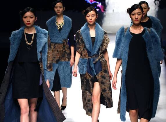 Models showcase fashion designs by Zoual Yanti during China s fashion week in Beijing on March 31, 2016. Chinese fashion designers are becoming an international force with both European and American fashion houses looking at the new, fresh Chinese clothing-minds as potential partners in future clothing brands.  PEK2016033122 STEPHENxSHAVER