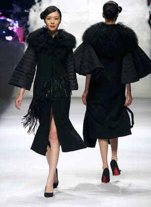 Models showcase fashion designs by Zoual Yanti during China s fashion week in Beijing on March 31, 2016. Chinese fashion designers are becoming an international force with both European and American fashion houses looking at the new, fresh Chinese clothing-minds as potential partners in future clothing brands.  PEK2016033132 STEPHENxSHAVER