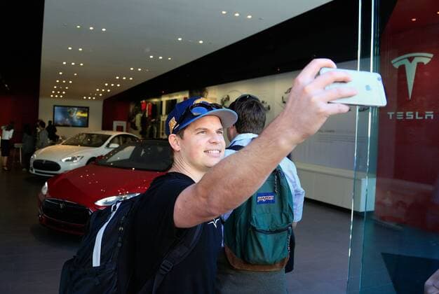Tesla Model 3 March 31, 2016 - CA, USA - SAN DIEGO, CA-MARCH 31, 2016: .Chris Thinnes of San Marcos takes a selfie as he makes his way to the front of the line of the Tesla Store at Westfield UTC in La Jolla where people lined up to be among the first to reserve the new Tesla 3, the consumer model electric car the first is releasing in 2017. USA - ZUMAs44_