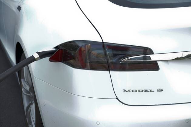 Tesla Model 3 April 1, 2016 - Tesla has unveiled its much-anticipated Model 3 electric car, its lowest-cost vehicle to date at $35,000. Tesla plans to produce about 500,000 vehicles a year once production. The California-based company needs the vehicle to prove popular if it is to stay in business. The first deliveries of the vehicle are scheduled to start in late 2017. Pictured: Sept. 5, 2015 - Topeka, Kansas, U.S - Tesla plugged in and charging at the supercharger station in the Arby s parking lot. Topeka United States of America - ZUMAr142