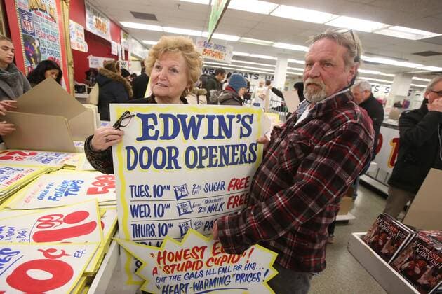 April 3, 2016 - Toronto, ON, Canada - TORONTO, ON - APRIL 3 - -Edith Vinciarelli with her son Donald Stewart holds up a sign that she wants to buy at Honest Ed s hand painted sign sale. Toronto Canada  - ZUMAt14_