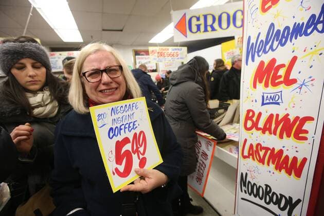 April 3, 2016 - Toronto, ON, Canada - TORONTO, ON - APRIL 3 - -Nadia Murchison holding back tears, holds up a sign(that reminds her of her mother) that she wants to buy at Honest Ed s hand painted sign sale. Toronto Canada  - ZUMAt14_