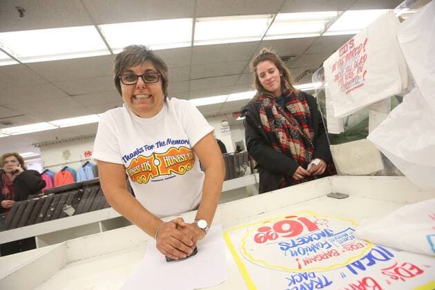 April 3, 2016 - Toronto, ON, Canada - TORONTO, ON - APRIL 3 - -Franca Longobardi, 30 year Honest Ed employee places a authenticity stamp on signs that are purchased at Honest Ed s hand painted sign sale. Toronto Canada  - ZUMAt14_