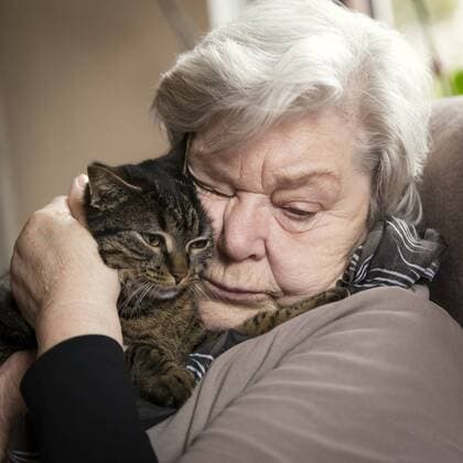 Portrait of senior woman cuddling with her cat model released Symbolfoto property released  MIDF000719